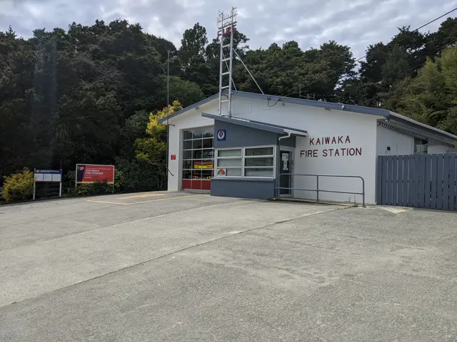 The image shows a building with windows and a door, a metal fence, a signboard with text on it, a...