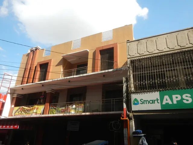 The image shows a building with a sign that reads "Smart APS" on the side of it, surrounded by...