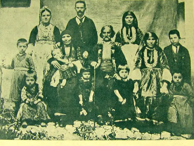 The image shows an old black and white photo of a family posing for a picture in front of a wall...
