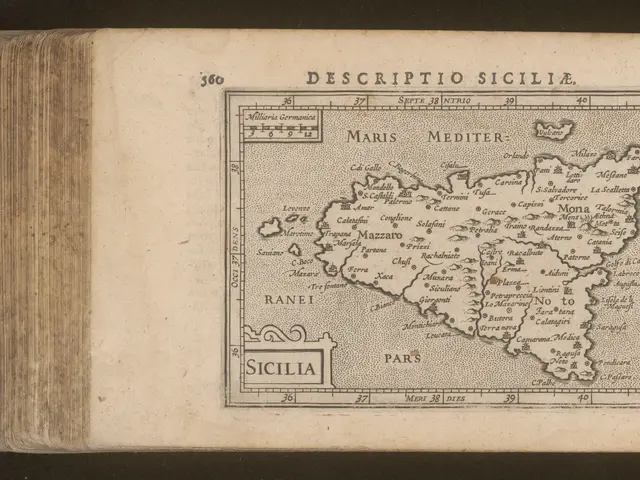 The image shows an old book with a map of Sicily on it. The map is detailed and shows the various...