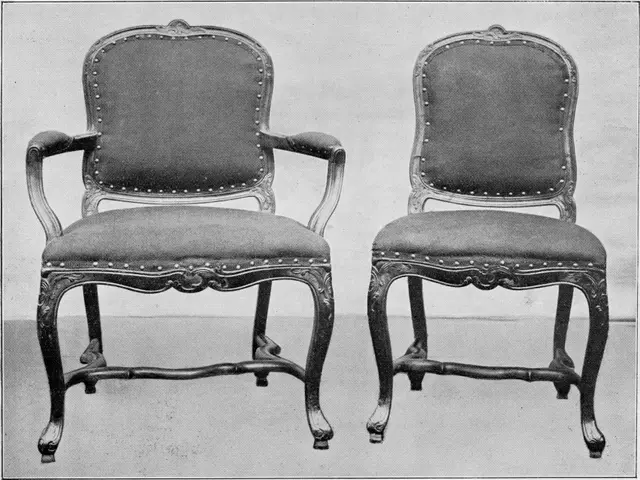 The image shows a black and white photo of a pair of Louis XV style armchairs. The chairs have a...