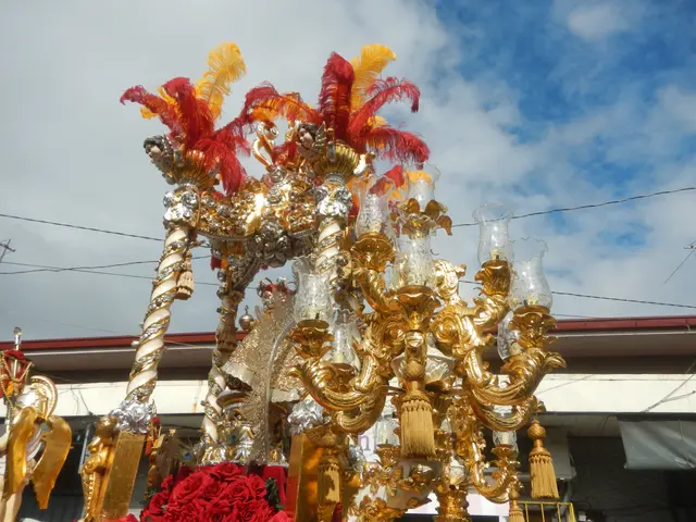 The image shows a float in a carnival parade with a large gold and red float adorned with flowers...