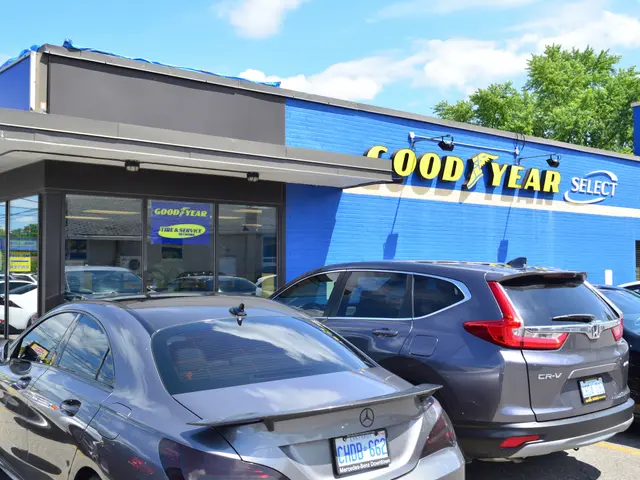 The image shows a Goodyear Select car dealership with cars parked in front of it. The building has...