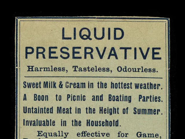 The image shows a black background with a paper in the center featuring text that reads "Liquid...