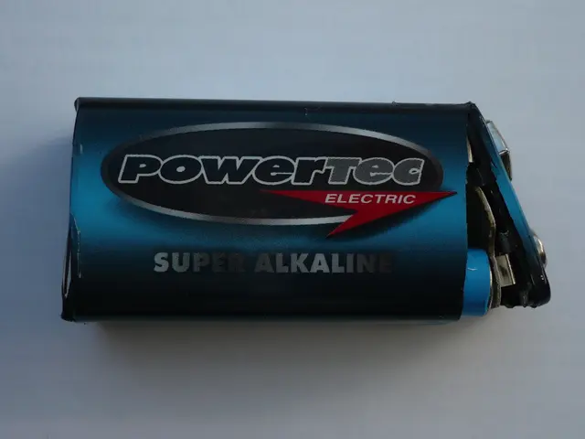 The image shows a blue Powertec Super Alkaline battery on a white surface. The battery is labeled...