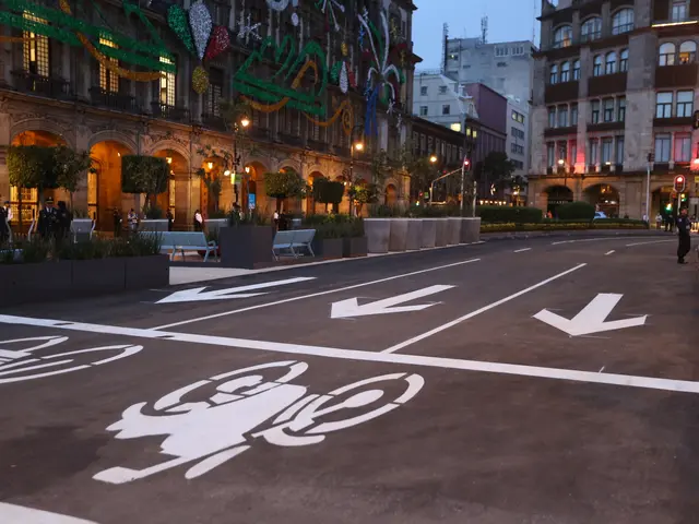 The image shows a city street with a bike lane painted on it, surrounded by buildings, street...