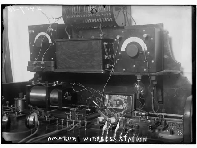 The image shows an old black and white photo of an amateur wireless station, with various...