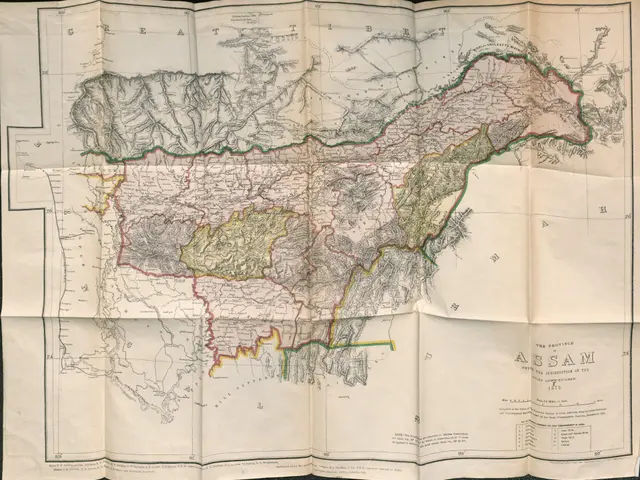 The image shows an old map of the provinces of Assam, India, with text on the paper and a black...