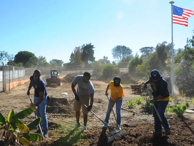The image shows a group of people working in a garden, with some of them holding rakes in their...