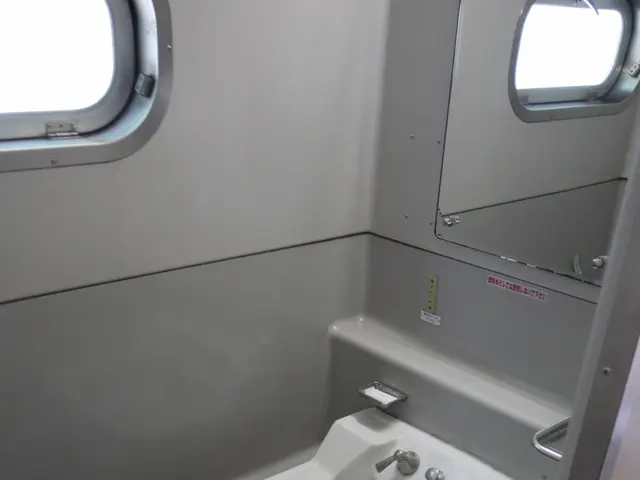 The image shows a small bathroom with a washbasin, taps, a mirror, a dustbin on the floor, and two...