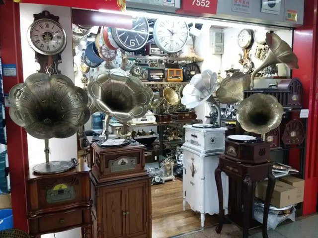 The image shows a room filled with lots of old gramophones and clocks, as well as other musical...