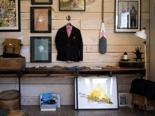The image shows a room with a wooden wall adorned with photo frames, a coat hung on a hanger,...