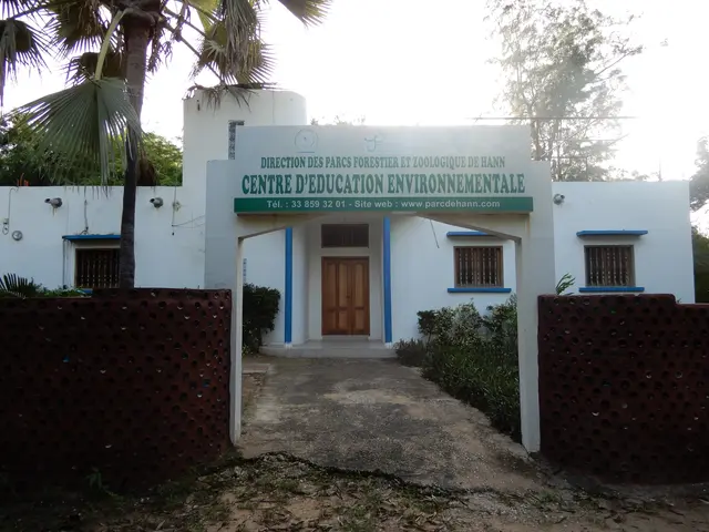 The image shows the entrance to a building with a sign that reads "Centre d'Education...