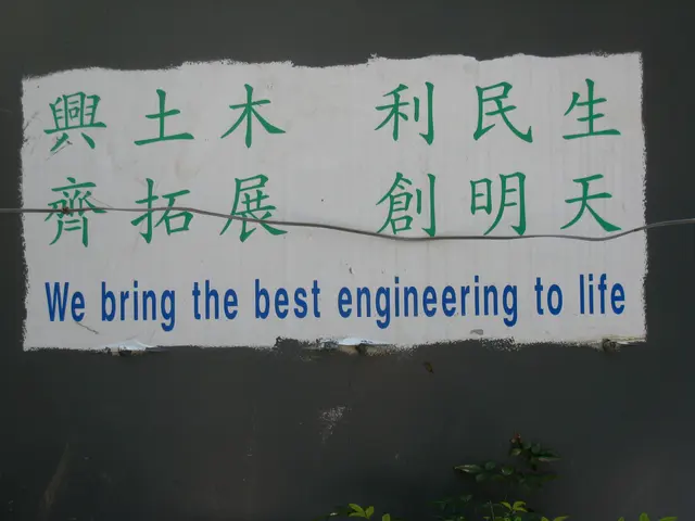The image shows a sign on the side of a building that reads "We Bring the Best Engineering to Life"...