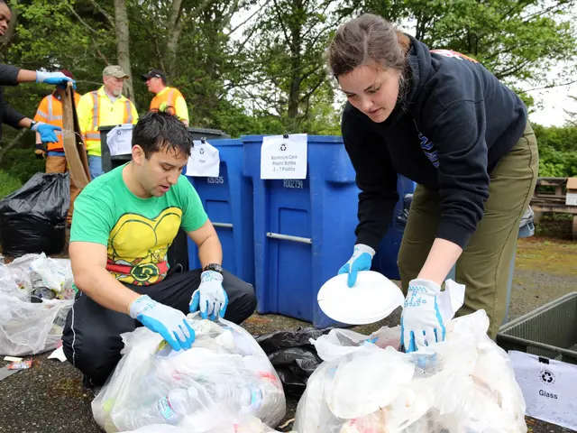 The image shows a group of people picking up trash in a park. We can see a man and a woman in the...