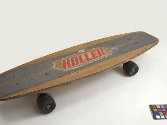 The image shows a wooden skateboard with the word "Roller" written on it, sitting on a white...