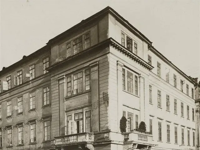 The image shows an old building with windows, steps with railings, boards with text, and pots with...