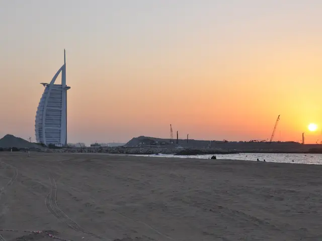 The image shows the iconic Burj Al Arab Hotel in Dubai, UAE, surrounded by sand, water, cranes,...