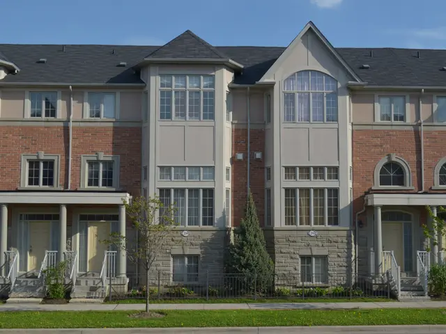 The image shows a row of townhouses in a residential neighborhood, with windows, doors, pillars,...