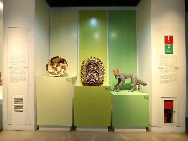 The image shows a room filled with lots of different types of art on display, including sculptures...