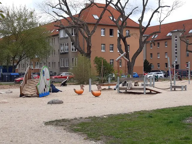 The image shows a playground in the middle of a park with a variety of toys, including a slide,...