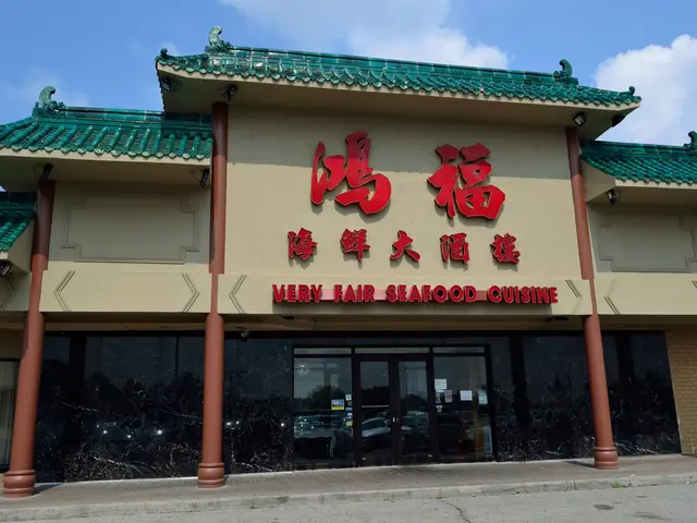 The image shows a very fair seafood restaurant with glass walls and doors, pillars, and text on the...