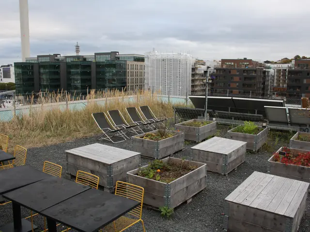 The image shows a rooftop garden with tables and chairs arranged on top of it, surrounded by lush...