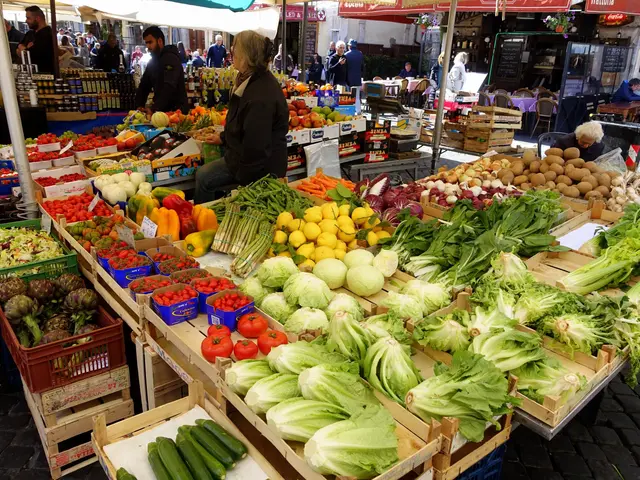 The image shows a bustling outdoor market with a variety of fruits and vegetables on display. There...