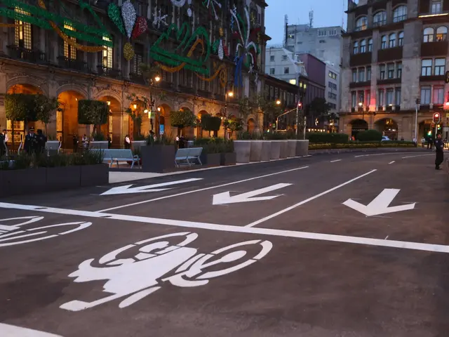 The image shows a city street with a bike lane painted on it, surrounded by buildings, street...
