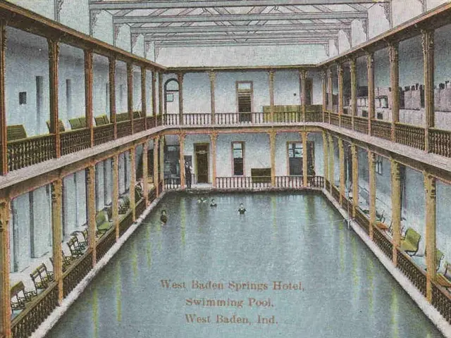 The image shows an old postcard of the West Baden Springs Hotel's swimming pool. It features a...