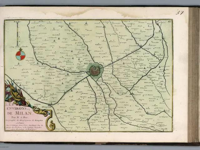 The image shows an open book with a map of the city of Milan on it. The map is detailed and shows...