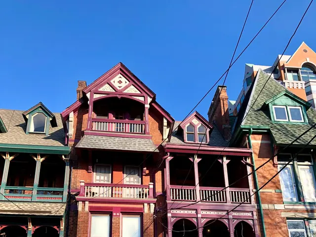 The image shows a row of Victorian-style houses in Toronto, Ontario, Canada. The houses have...