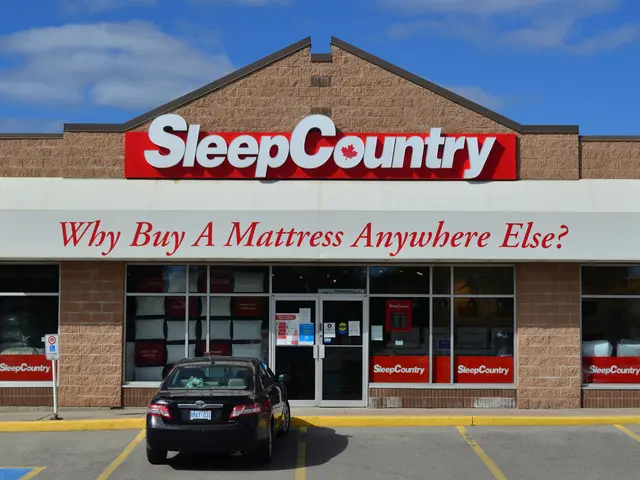 The image shows a Sleep Country store with cars parked in front of it, a sign board attached to a...