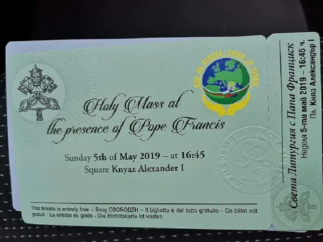 The image shows a black surface with a card featuring text and a logo, which reads "Holy Mass at...