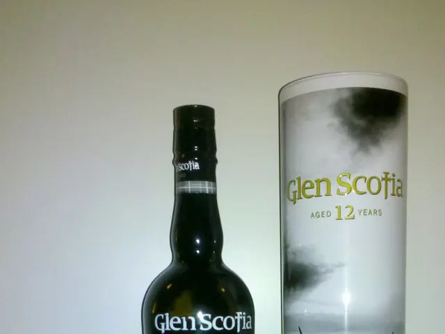 The image shows a bottle of Glen Scotia 12 Year Old Scotch Whisky and a glass of the same whisky...