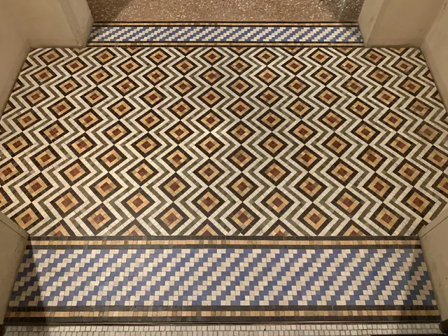 The image shows a Victorian tiled floor in London before restoration. The floor is composed of a...