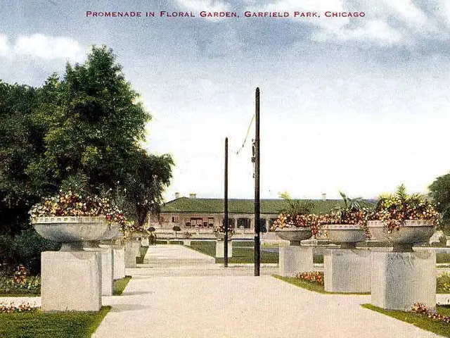 The image shows a promenade in Floral Garden, Garfield Park, Chicago. It features a walkway lined...