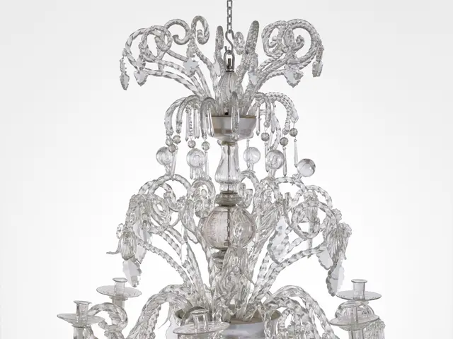 The image shows a large Murano glass chandelier with six lights hanging from the ceiling against a...