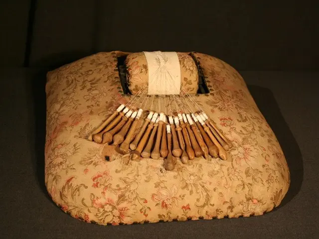 The image shows an old musical instrument, a kalimba, on display in a museum. It is placed on a...