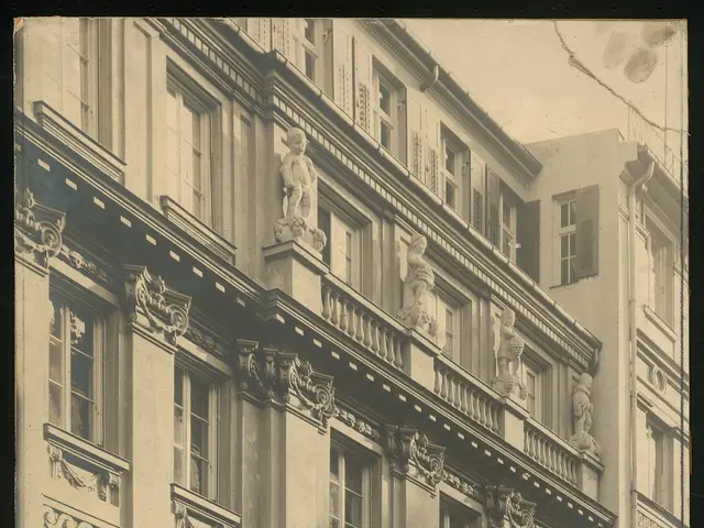 The image shows an old building with many windows and sculptures adorning its facade. The building...