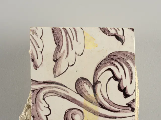 The image shows a close up of a tile with a design on it. The tile is white in color and the design...