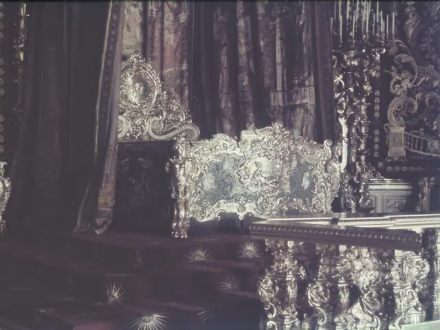 The image shows an old photo of a room with ornate furniture, including a bed, a table, and...