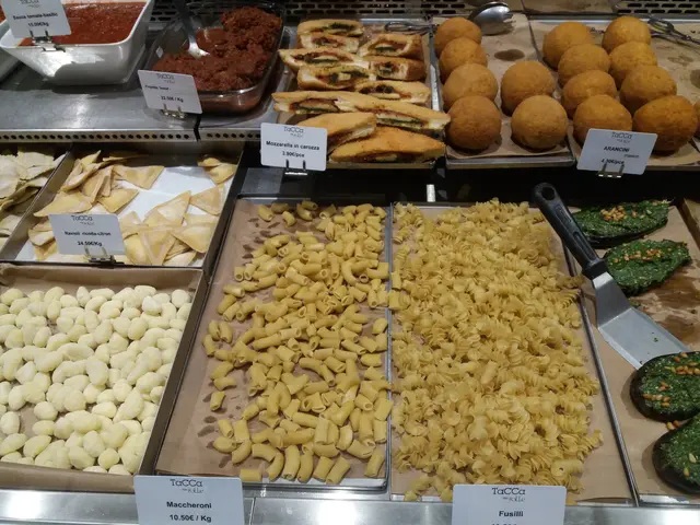 The image shows a display case filled with a variety of Italian food items, including trays and...