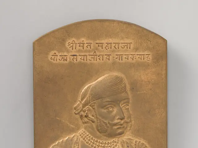 The image shows a brass plaque with a portrait of a man in a turban, believed to be the Maharaja of...
