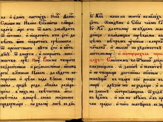 The image shows an open book with writing on it against a dark background. The book is believed to...