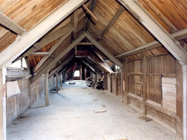 The image shows an old barn with wooden walls and a wooden roof. Inside the barn, there are a few...