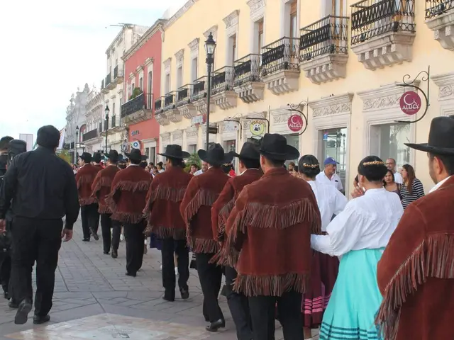 The image shows a group of people walking down a street lined with buildings, street poles, street...