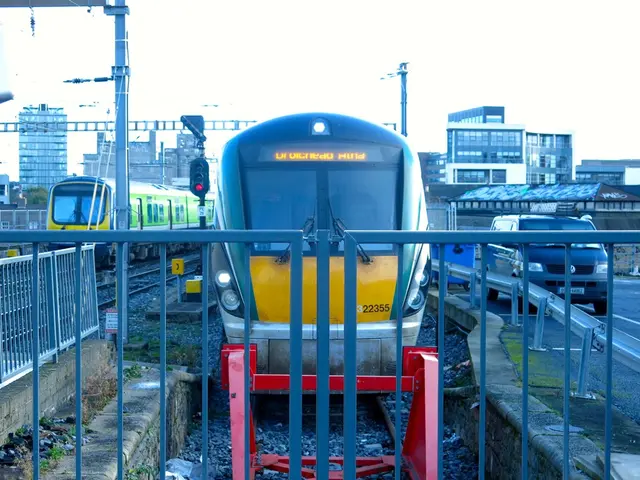 In this image two trains are on the rail track. Front side of image there is a fence. There are few...