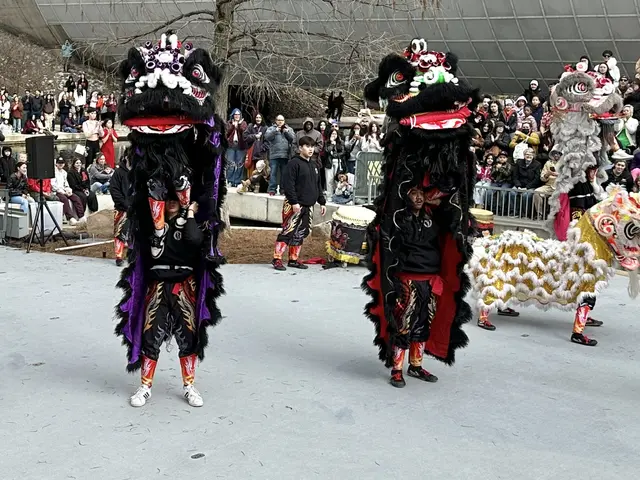 The image shows a group of people wearing costumes and holding musical instruments, standing on the...
