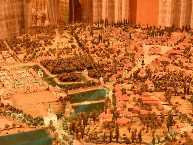 The image shows a model of a city on display in a museum, with buildings, trees, and water visible....